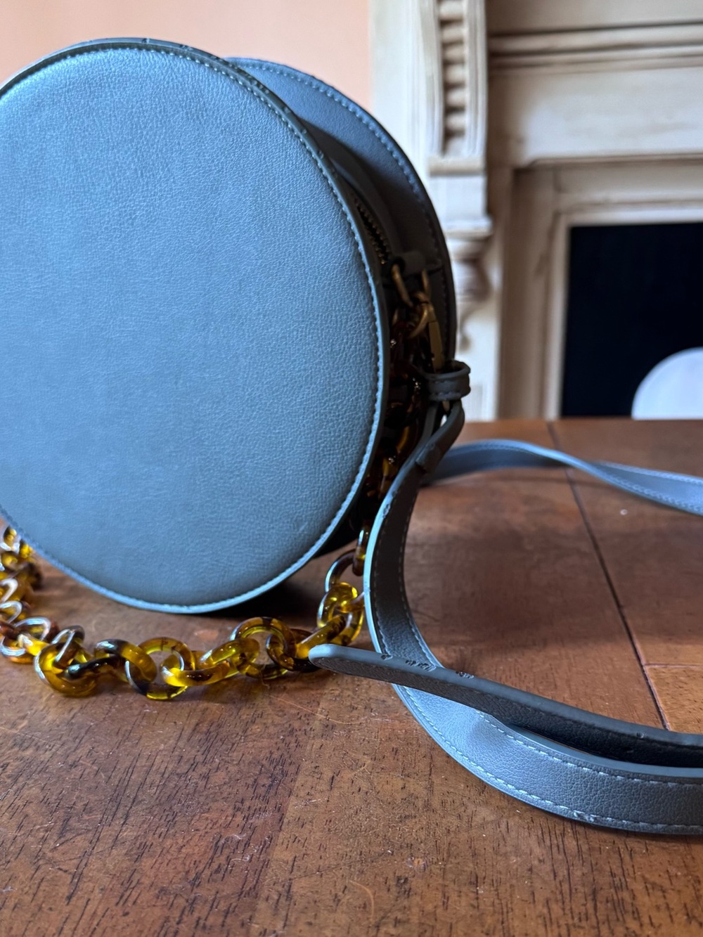 Round Gray Crossbody Bag with Tortoiseshell Chain Accent